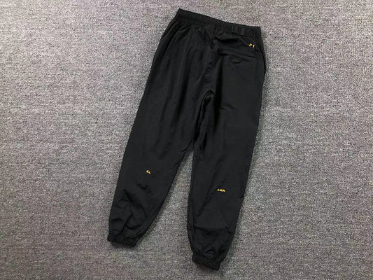 NIKE X DRAKE NOCTA TRACK BLACK AND YELLOW PANTS
